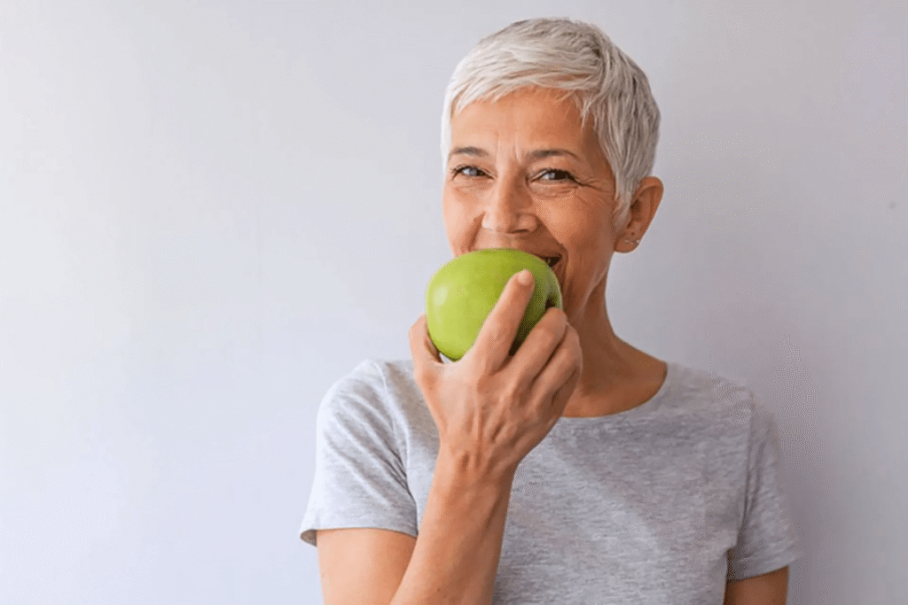 Longevity woman eating an apple 1